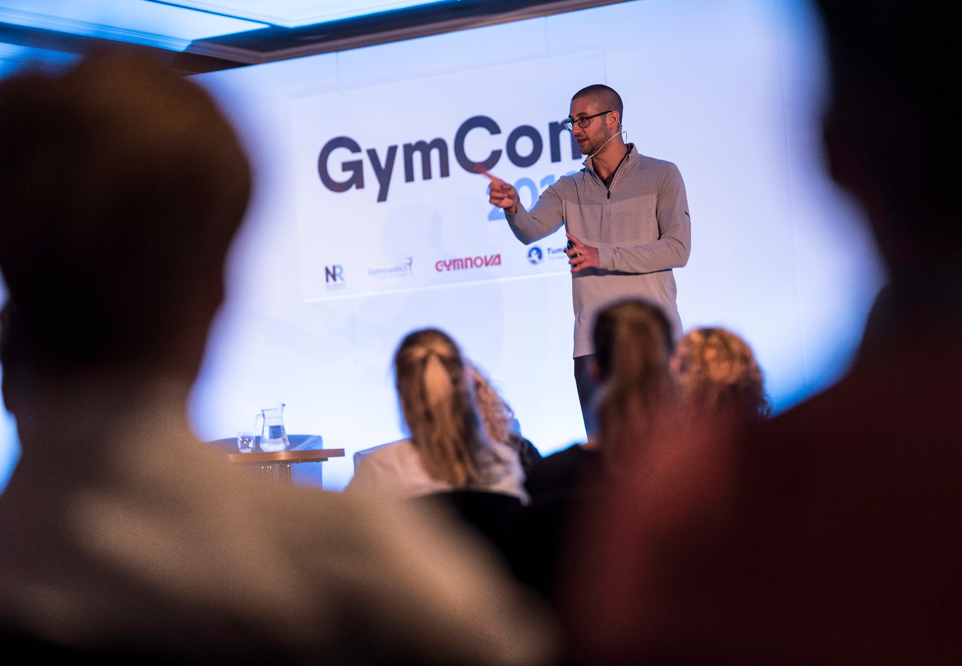 Nick Ruddock speaking on stage at GymCon